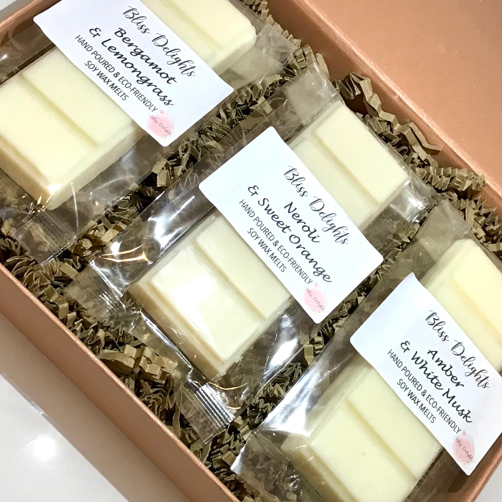 Box of Bliss Delights hand-poured soy wax melts with labels on a white background