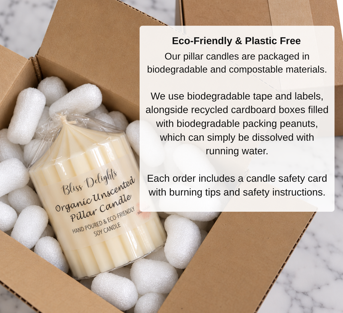 Bliss Delights unscented soy pillar candle in clear biodegradable packaging, nestled in white compostable protective packing peanuts inside a cardboard box.