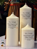 Three cream-coloured Bliss Delights Velvet Rose & Oud soy wax pillar candles in small, medium and large sizes. The candles are arranged against a white marble background.